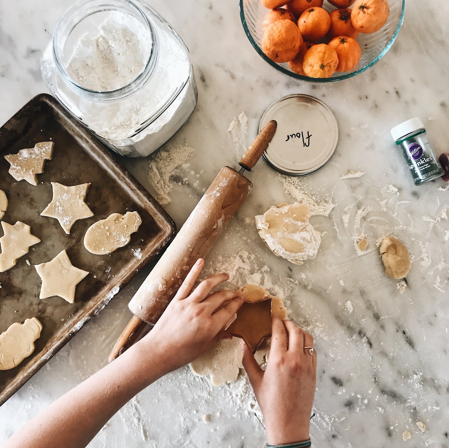 A homeschool kid cutting star shapes out of homemade cookie dough.