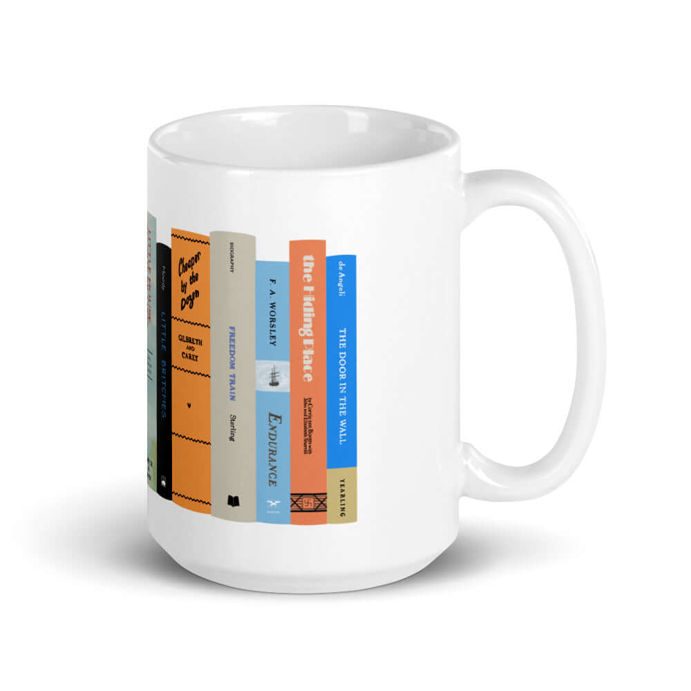 The Peaceful Preschool Mothering By The Book mug in white with a painting of a bookshelf with books on it.